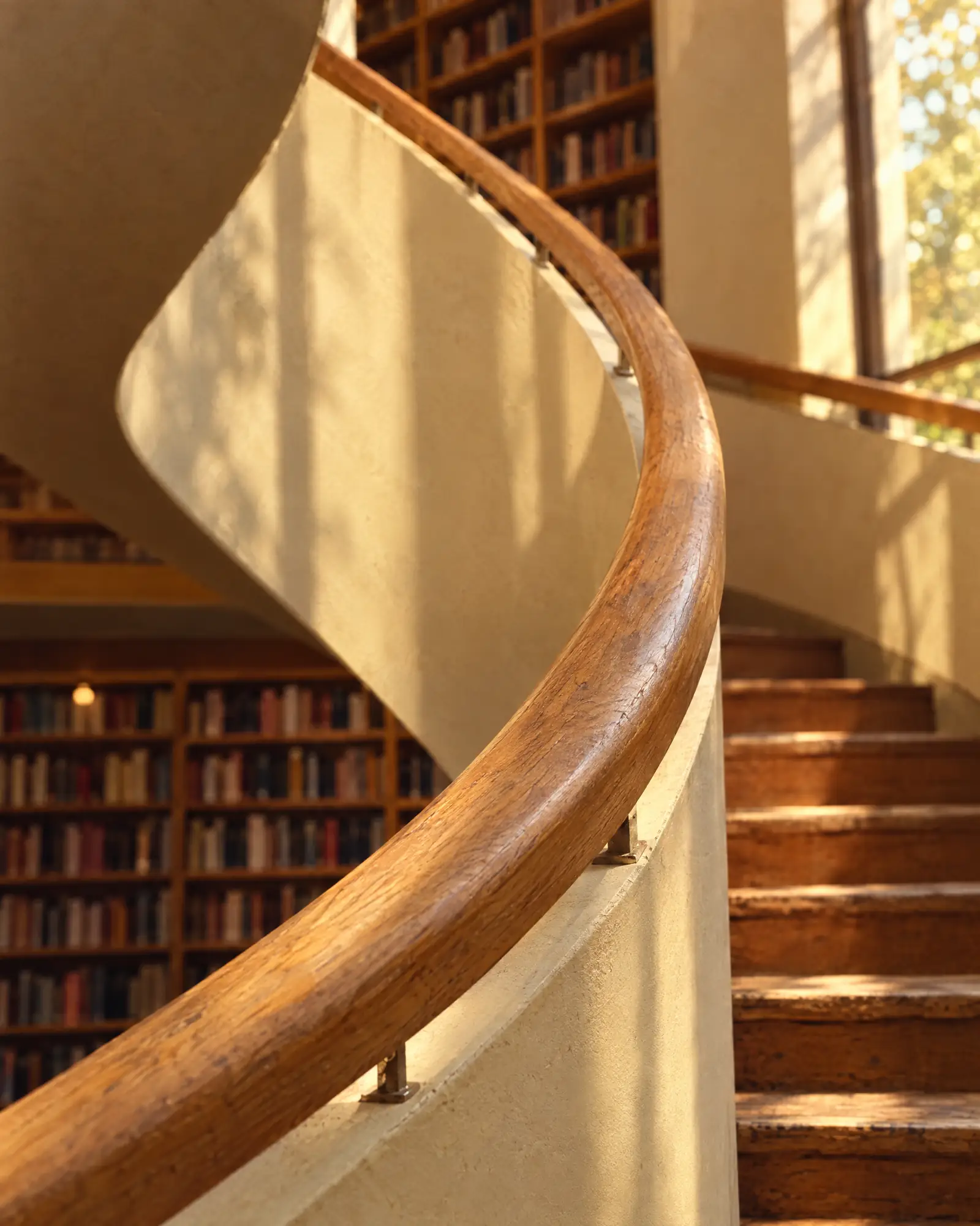 The oak handrail runs unbroken for five floors